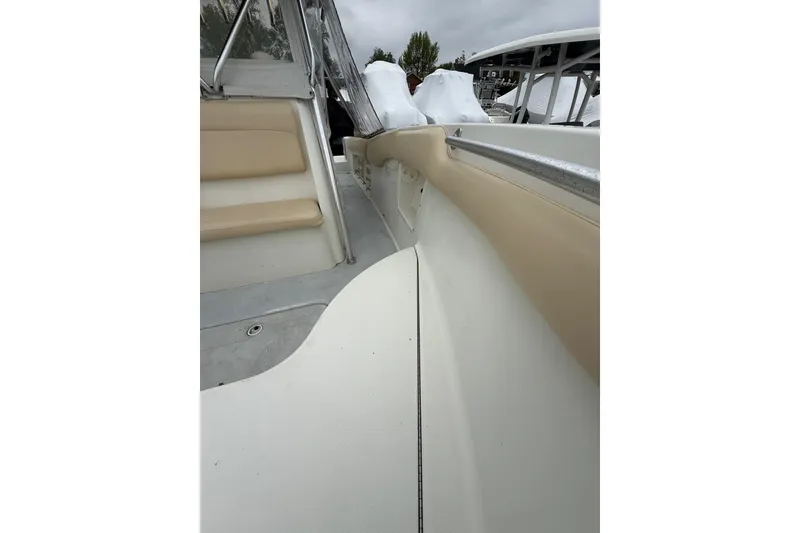 Slide: The Image of 2003 Hydra-Sports Vector 2800 CC boat interior with beige seating and railing. - 30