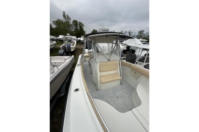 Slide: The Image of 2003 Hydra-Sports Vector 2800 CC boat with beige seating, docked among other boats. - 35
