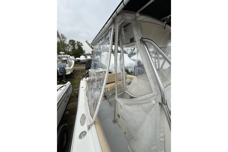 Slide: The Image of 2003 Hydra-Sports Vector 2800 CC boat with protective enclosure, docked outdoors. - 37
