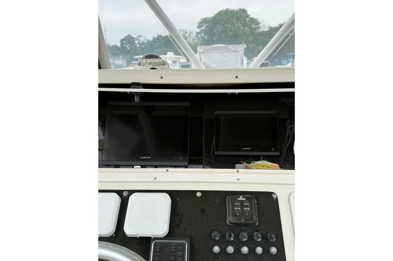Slide: The Image of 2003 Hydra-Sports Vector 2800 CC dashboard with Garmin displays and control panel. - 39