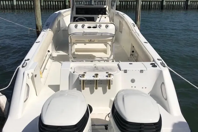Slide: The Image of 2003 Hydra-Sports Vector 2800 CC boat with dual engines, docked on calm water. - 4