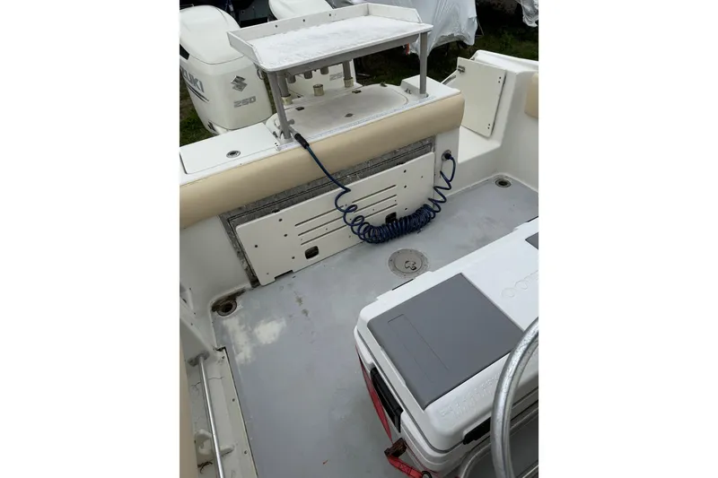 Slide: The Image of 2003 Hydra-Sports Vector 2800 CC boat interior with Suzuki engines and fishing equipment. - 40