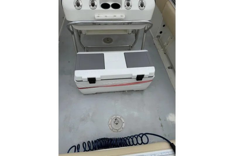 Slide: The Image of 2003 Hydra-Sports Vector 2800 CC boat interior with cooler and fishing rod holders. - 41