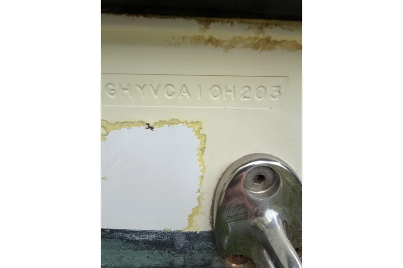 Slide: The Image of 2003 Hydra-Sports Vector 2800 CC hull identification number and metal fitting detail. - 44