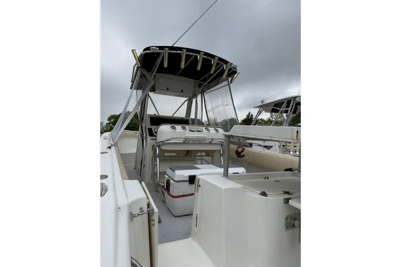 Slide: The Image of 2003 Hydra-Sports Vector 2800 CC boat interior with console and seating under cloudy sky. - 47