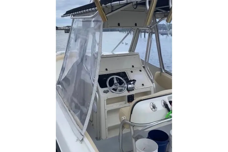 Slide: The Image of 2003 Hydra-Sports Vector 2800 CC boat cockpit with steering wheel and controls. - 6