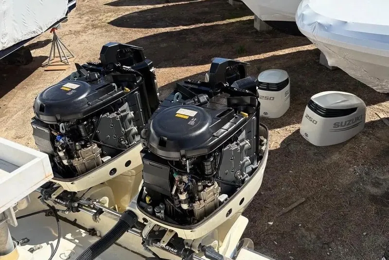 Slide: The Image of Twin outboard engines on a 2003 Hydra-Sports Vector 2800 CC boat, with Suzuki covers nearby. - 7