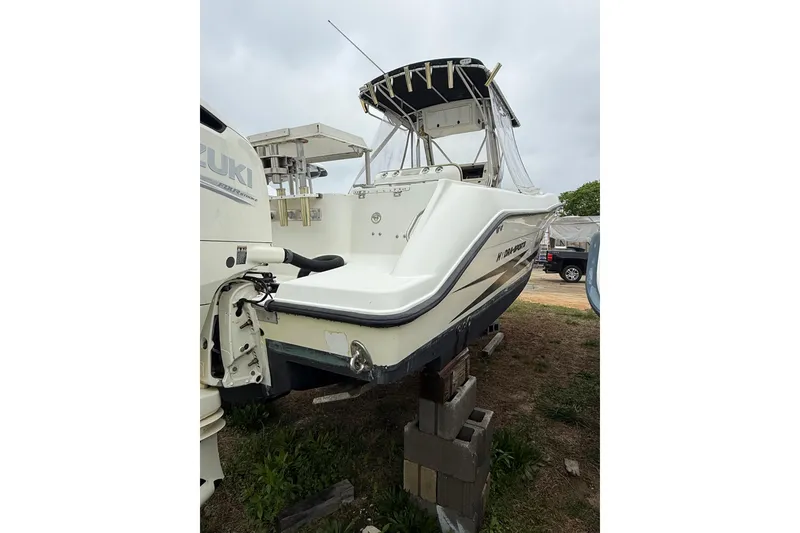 Slide: The Image of 2003 Hydra-Sports Vector 2800 CC boat on blocks, featuring Suzuki outboard motor. - 8