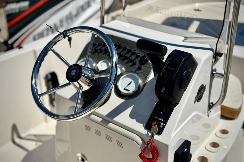 Slide: The Image of Steering console of 2025 Carolina Skiff 178 JLS boat with controls and gauges. - 12