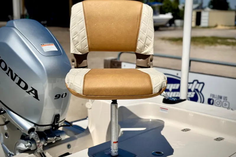 Slide: The Image of 2025 Carolina Skiff 178 JLS boat seat with Honda 90 engine in background. - 15