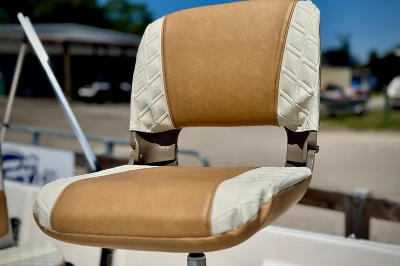 Slide: The Image of 2025 Carolina Skiff 178 JLS boat seat with tan and white upholstery. - 16