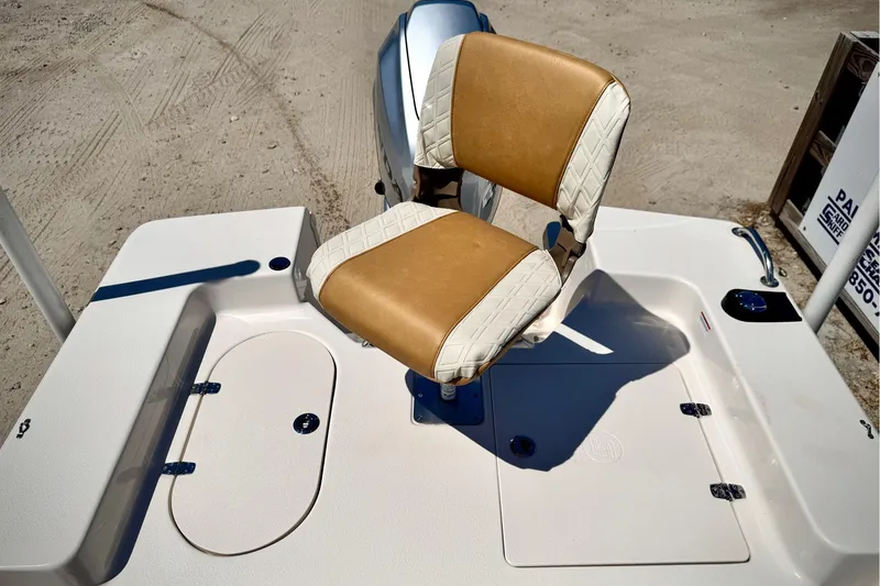 Slide: The Image of 2025 Carolina Skiff 178 JLS boat seat with tan and white upholstery on deck. - 18