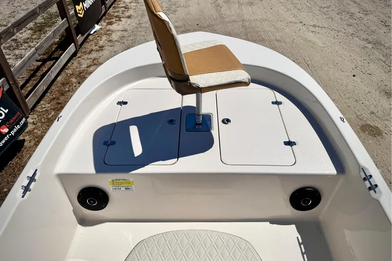Slide: The Image of 2025 Carolina Skiff 178 JLS boat deck with seating and storage compartments. - 19