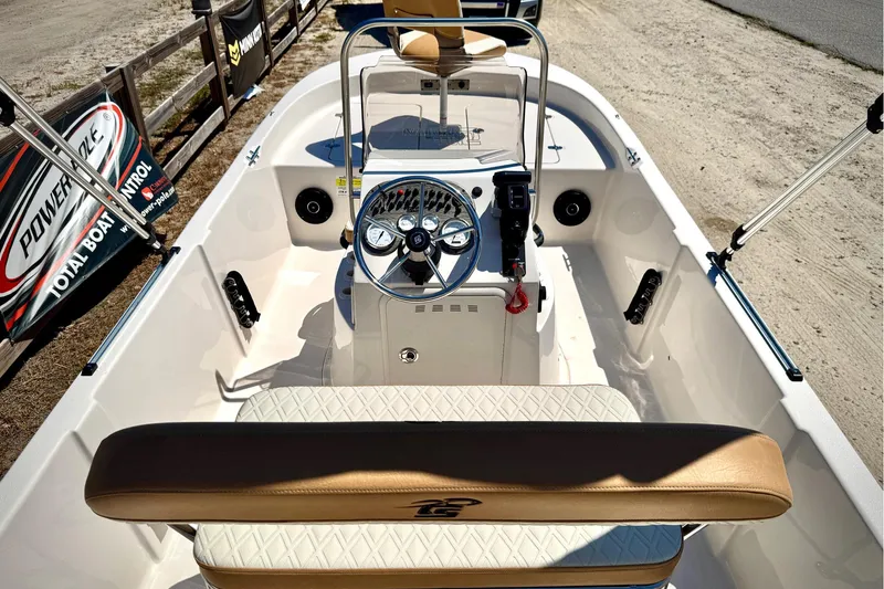 Slide: The Image of 2025 Carolina Skiff 178 JLS boat interior with steering wheel and seating. - 23
