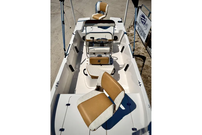 Slide: The Image of 2025 Carolina Skiff 178 JLS boat interior with tan and white seating. - 24