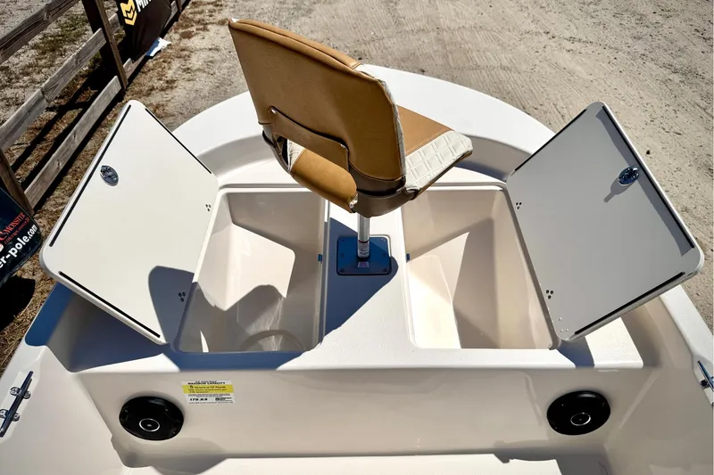 Slide: The Image of 2025 Carolina Skiff 178 JLS boat interior with storage compartments and swivel seat. - 25
