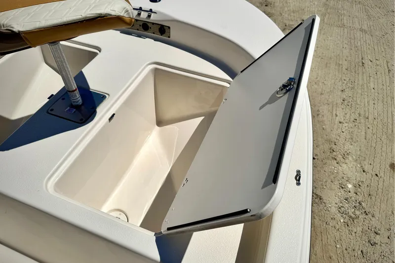 Slide: The Image of 2025 Carolina Skiff 178 JLS boat storage compartment with open hatch on deck. - 27