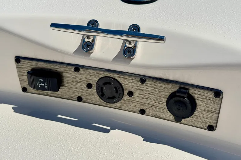 Slide: The Image of 2025 Carolina Skiff 178 JLS boat control panel with trim switch and 12V outlet. - 28