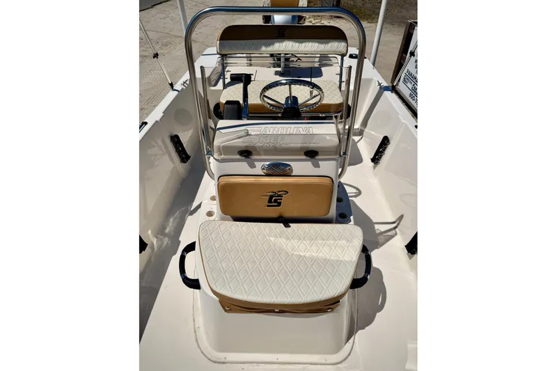 Slide: The Image of 2025 Carolina Skiff 178 JLS boat interior with steering console and cushioned seating. - 29