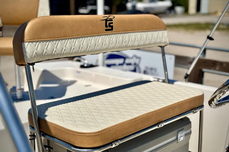Slide: The Image of 2025 Carolina Skiff 178 JLS boat seat with tan and white diamond-pattern upholstery. - 8
