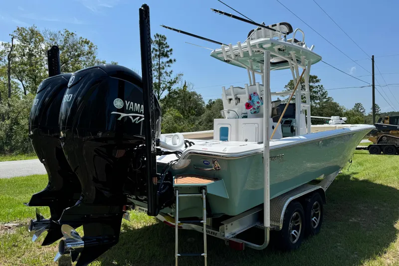 Slide: The Image of 2024 Tidewater 2700 Carolina Bay boat with dual Yamaha engines on a trailer. - 3