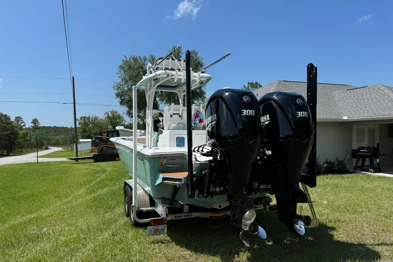 Slide: The Image of 2024 Tidewater 2700 Carolina Bay boat with dual Yamaha 300 engines on a trailer. - 4