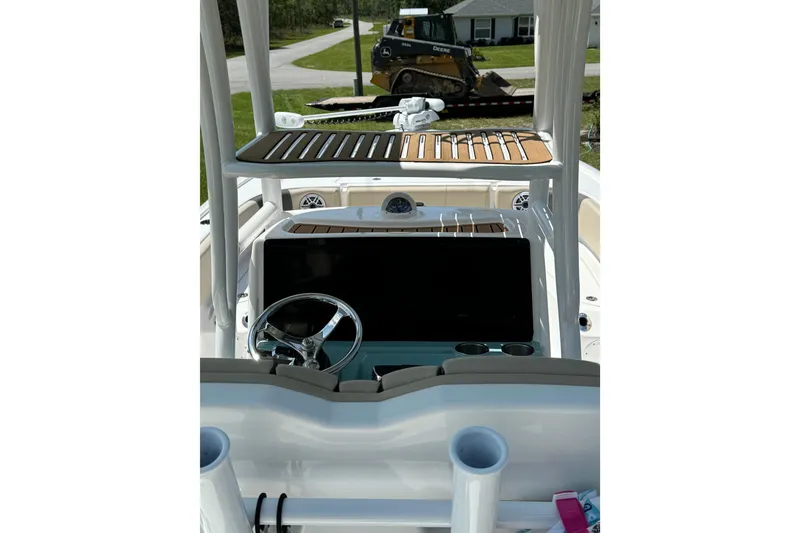 Slide: The Image of 2024 Tidewater 2700 Carolina Bay boat interior with steering wheel and dashboard. - 7