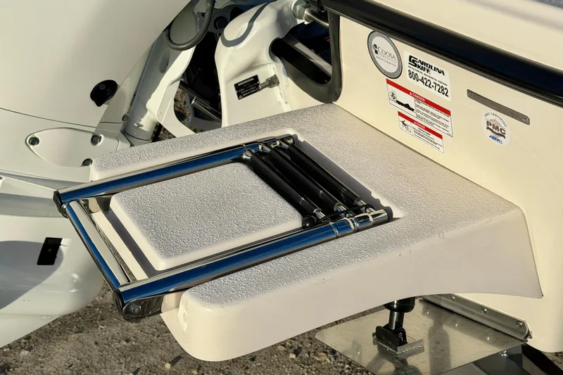 Slide: The Image of 2026 Carolina Skiff 178 JLS boat ladder and motor detail, showcasing design and functionality. - 10
