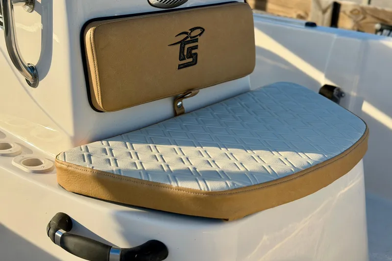 Slide: The Image of 2026 Carolina Skiff 178 JLS boat seat with tan and white cushioned design. - 12