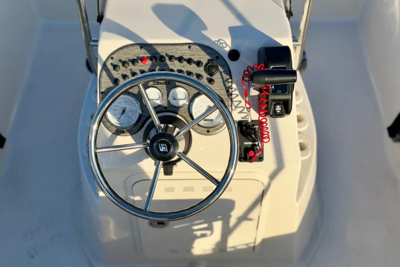 Slide: The Image of Steering console of 2026 Carolina Skiff 178 JLS boat with gauges and controls. - 15