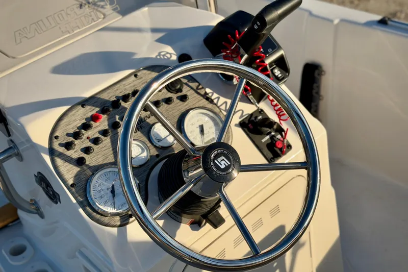 Slide: The Image of Steering console of 2026 Carolina Skiff 178 JLS boat with gauges and controls. - 16