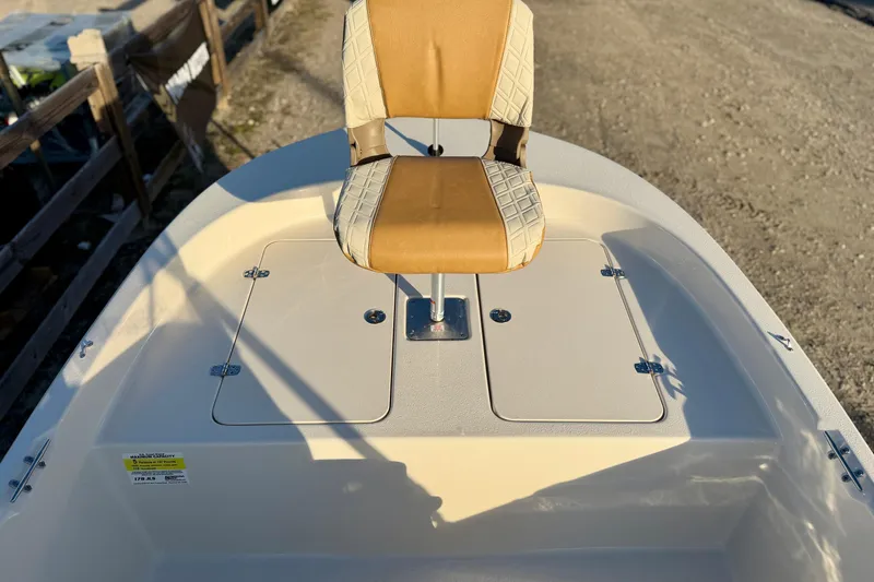 Slide: The Image of 2026 Carolina Skiff 178 JLS boat with tan seat and storage compartments. - 17