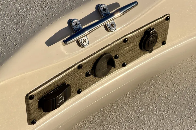 Slide: The Image of Close-up of 2026 Carolina Skiff 178 JLS boat control panel with switches and outlets. - 19