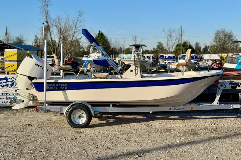 Slide: The Image of 2026 Carolina Skiff 178 JLS boat on trailer, featuring Honda outboard motor. - 2