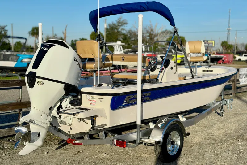 Slide: The Image of 2026 Carolina Skiff 178 JLS boat with Honda 115 engine on trailer, outdoor display. - 26