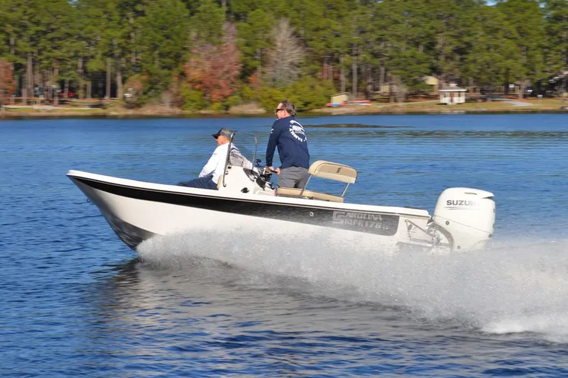 Slide: The Image of Manufacturer Provided Image: 2025 Carolina Skiff 178 JLS boat cruising on a lake with two passengers. - 29