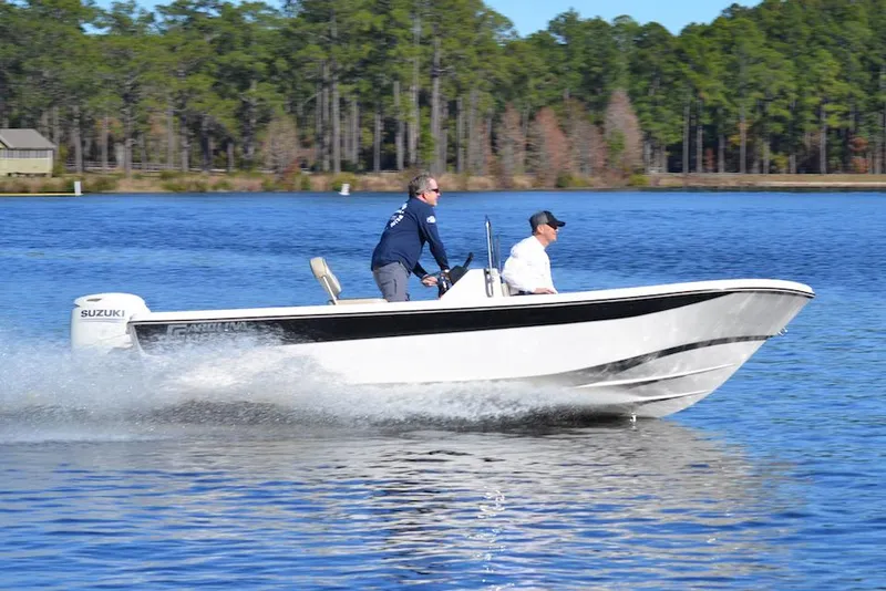 Slide: The Image of Manufacturer Provided Image: 2025 Carolina Skiff 178 JLS boat cruising on a lake with two passengers. - 31