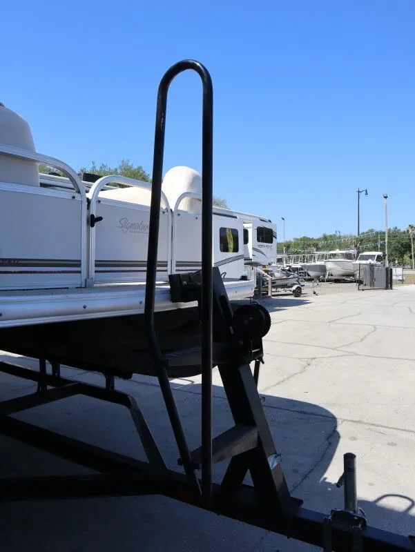 Slide: The Image of 2011 Sun Tracker Party Barge 21 on a trailer outdoors. - 20