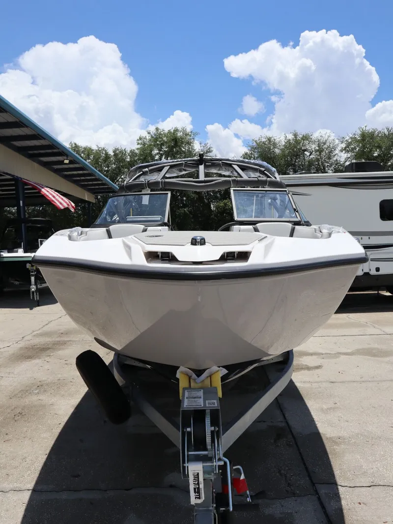 Slide: The Image of 2026 Yamaha Boats SX250 on a trailer under blue sky. - 3