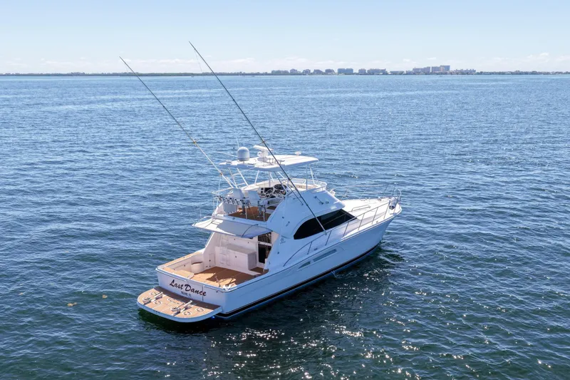 The Image of 2006 Riviera 47 Open Flybridge Series II yacht on open water, clear sky background. - 0