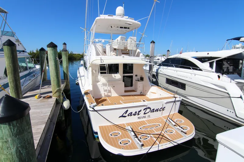 Slide: The Image of 2006 Riviera 47 Open Flybridge Series II yacht docked in Miami marina. - 13