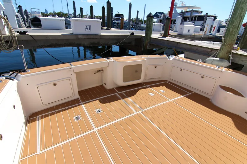 Slide: The Image of 2006 Riviera 47 Open Flybridge Series II yacht deck at marina. - 16