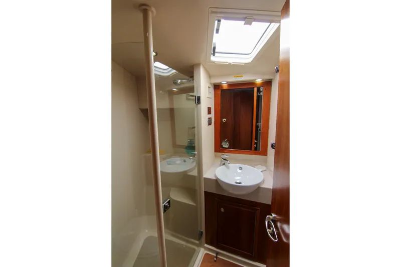 Slide: The Image of Luxurious bathroom in 2006 Riviera 47 Open Flybridge Series II yacht, featuring modern sink and mirror. - 17