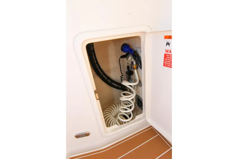 Slide: The Image of Storage compartment with coiled hose in 2006 Riviera 47 Open Flybridge Series II yacht. - 19