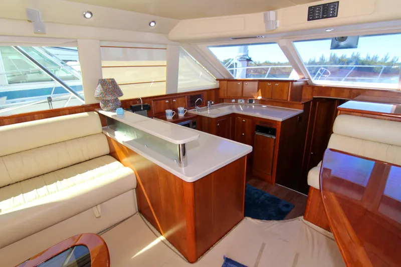 Slide: The Image of Luxurious interior of 2006 Riviera 47 Open Flybridge Series II yacht with elegant wood finishes. - 23