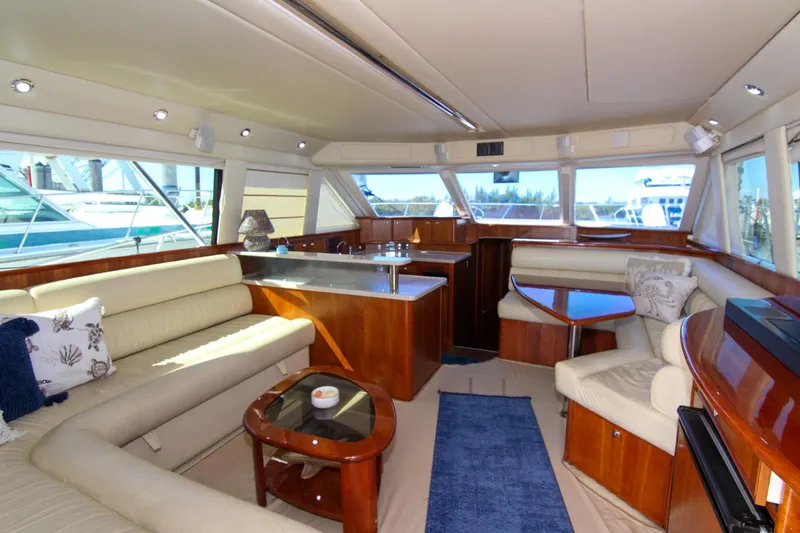 Slide: The Image of Luxurious interior of 2006 Riviera 47 Open Flybridge yacht with elegant seating and wood finishes. - 24