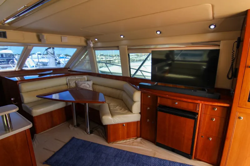 Slide: The Image of Luxurious interior of 2006 Riviera 47 Open Flybridge yacht with seating and TV. - 26
