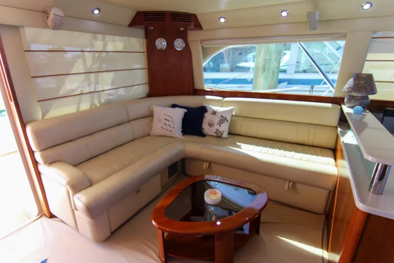 Slide: The Image of Luxurious interior of 2006 Riviera 47 Open Flybridge yacht with plush seating and elegant decor. - 28