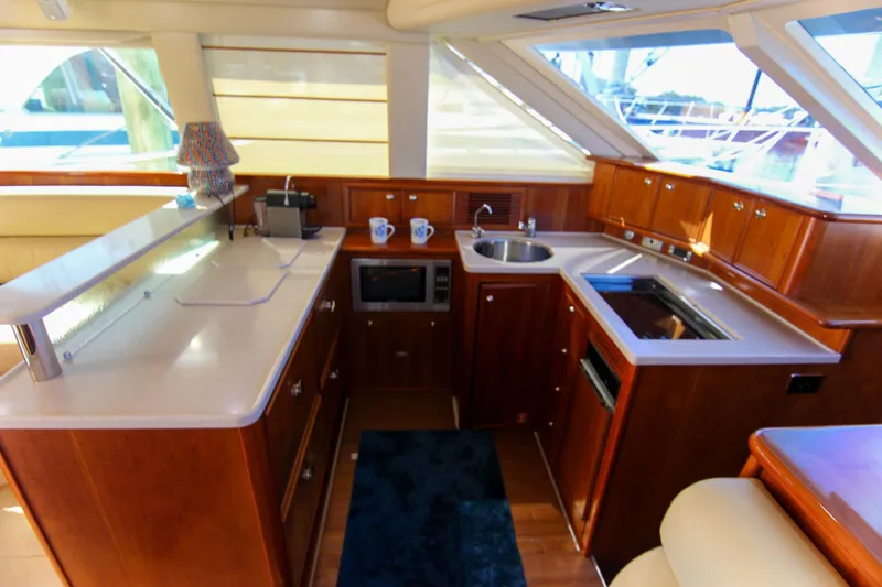 Slide: The Image of Luxurious 2006 Riviera 47 Open Flybridge Series II yacht interior with modern kitchen amenities. - 29