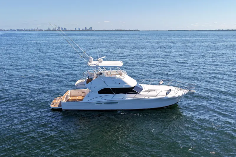 Slide: The Image of 2006 Riviera 47 Open Flybridge Series II yacht on calm ocean waters. - 3